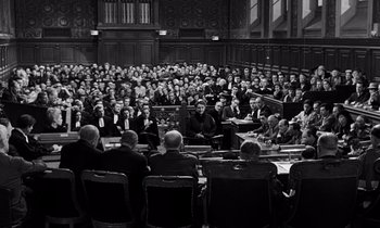 Movie still from “The Truth” (1960), directed by Henri-Georges Clouzot – A group of people sitting in front of a crowd; Extreme Wide shot, High angle