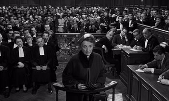 Movie still from “The Truth” (1960), directed by Henri-Georges Clouzot – An older woman in a courtroom with a crowd of people; Medium shot, High angle