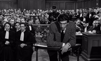 Movie still from “The Truth” (1960), directed by Henri-Georges Clouzot – A black and white photo of a man in a courtroom; Medium shot, High angle