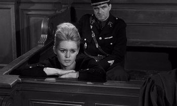 Movie still from “The Truth” (1960), directed by Henri-Georges Clouzot – A man and a woman sitting in a courtroom; Medium shot, Low angle