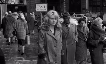 Movie still from “The Truth” (1960), directed by Henri-Georges Clouzot – Black and white photograph of a woman and two men on a street; Medium shot, Over the shoulder angle