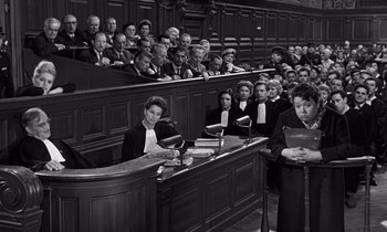 Movie still from “The Truth” (1960), directed by Henri-Georges Clouzot – A group of people sitting in a court room; Wide shot, High angle