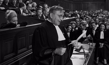 Movie still from “The Truth” (1960), directed by Henri-Georges Clouzot – An old man in a court room holding papers; Medium shot, Low angle