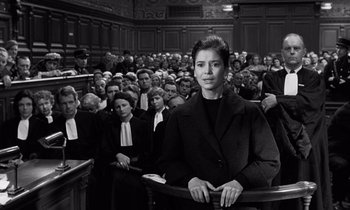 Movie still from “The Truth” (1960), directed by Henri-Georges Clouzot – A woman is sitting in front of a group of people; Medium shot, High angle