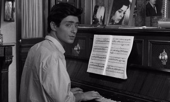Movie still from “The Truth” (1960), directed by Henri-Georges Clouzot – A man sitting at a piano with a sheet of music on it; Close Up shot, High angle