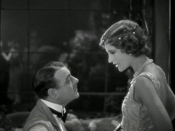 Movie still from “Ladies of Leisure” (1930), directed by Frank Capra – A man and a woman looking at one another; Medium shot, High angle