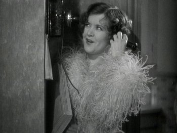 Movie still from “Ladies of Leisure” (1930), directed by Frank Capra – An old photo of a woman talking on the phone; Medium shot, High angle