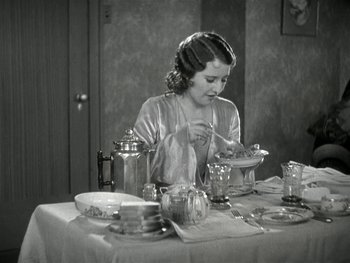 Movie still from “Ladies of Leisure” (1930), directed by Frank Capra – A woman sitting at a table with a plate of food in front of her; Medium shot, High angle