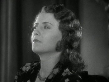 Movie still from “Ladies of Leisure” (1930), directed by Frank Capra – An old photo of a woman looking up at the sky; Close Up shot, Low angle