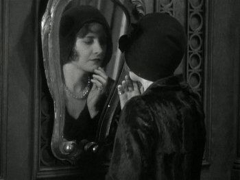 Movie still from “Ladies of Leisure” (1930), directed by Frank Capra – A woman looking at herself in the mirror; Close Up shot, Over the shoulder angle