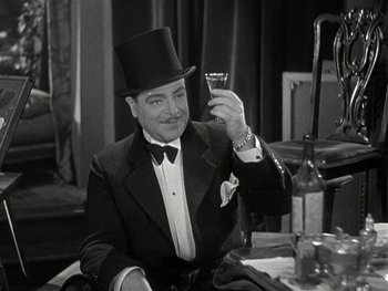 Movie still from “Ladies of Leisure” (1930), directed by Frank Capra – A man in a top hat holding up a shot glass; Medium shot, Low angle