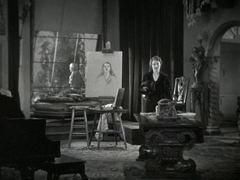 Movie still from “Ladies of Leisure” (1930), directed by Frank Capra – A woman standing in front of an easel in an art studio; Wide shot, Low angle