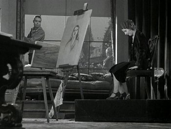 Movie still from “Ladies of Leisure” (1930), directed by Frank Capra – A woman sitting in front of a painting of a woman; Wide shot, Low angle