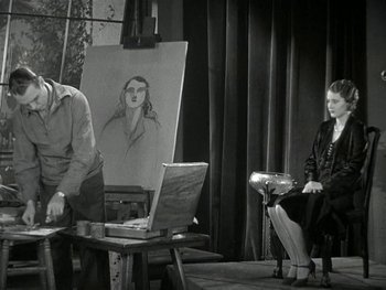 Movie still from “Ladies of Leisure” (1930), directed by Frank Capra – A man and a woman sitting in front of an easel; Medium shot, Low angle