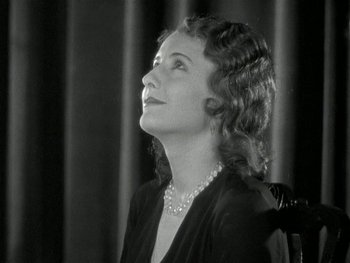 Movie still from “Ladies of Leisure” (1930), directed by Frank Capra – An old photo of a woman looking up at the sky; Close Up shot, Low angle