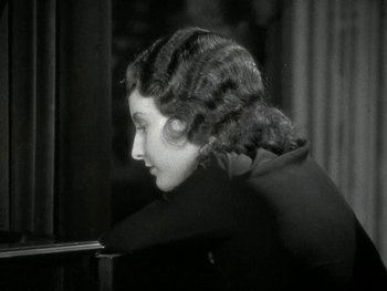 Movie still from “Ladies of Leisure” (1930), directed by Frank Capra – An old photo of a woman looking out of a window; Close Up shot, High angle