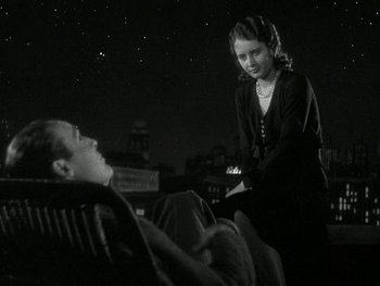 Movie still from “Ladies of Leisure” (1930), directed by Frank Capra – A man and a woman sitting on a chair; Medium shot, High angle