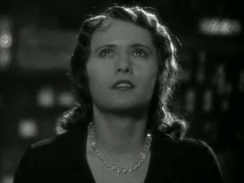 Movie still from “Ladies of Leisure” (1930), directed by Frank Capra – A black and white photo of a woman with a necklace; Close Up shot, Low angle