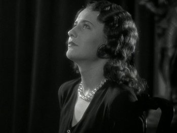 Movie still from “Ladies of Leisure” (1930), directed by Frank Capra – An old photo of a woman looking up at the sky; Close Up shot, Low angle