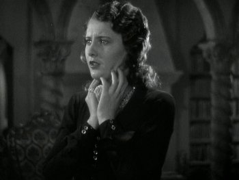 Movie still from “Ladies of Leisure” (1930), directed by Frank Capra – An old photo of a woman in a black dress; Close Up shot, Low angle