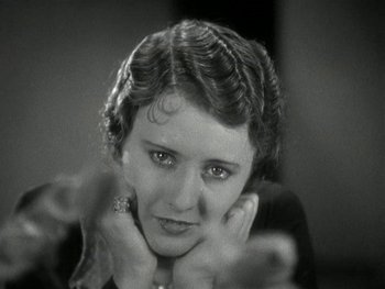 Movie still from “Ladies of Leisure” (1930), directed by Frank Capra – An old photo of an older woman with her hands under her chin; Close Up shot, Low angle