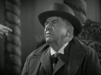 Movie still from “Ladies of Leisure” (1930), directed by Frank Capra – An older man wearing a hat and a coat; Close Up shot, Low angle