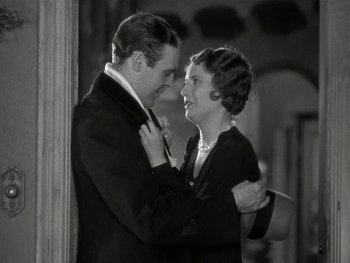Movie still from “Ladies of Leisure” (1930), directed by Frank Capra – A man and a woman embracing each other in front of a wall; Medium shot, Low angle