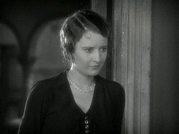 Movie still from “Ladies of Leisure” (1930), directed by Frank Capra – A young woman in a black shirt is looking at the camera; Close Up shot, Over the shoulder angle