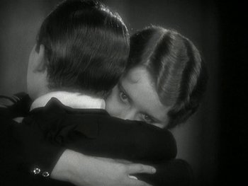 Movie still from “Ladies of Leisure” (1930), directed by Frank Capra – A man and a woman hugging each other in a black and white photo; Close Up shot, High angle