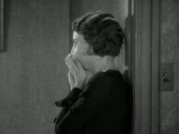 Movie still from “Ladies of Leisure” (1930), directed by Frank Capra – An old photo of an older woman leaning against a wall; Close Up shot, High angle