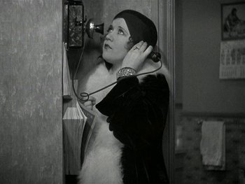 Movie still from “Ladies of Leisure” (1930), directed by Frank Capra – An old photo of a woman talking on a phone; Close Up shot, High angle