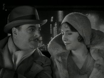 Movie still from “Ladies of Leisure” (1930), directed by Frank Capra – An old photo of a man and a woman; Close Up shot, Low angle