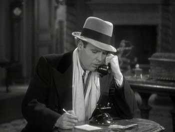 Movie still from “Ladies of Leisure” (1930), directed by Frank Capra – An old photo of a man talking on a phone; Medium shot, High angle