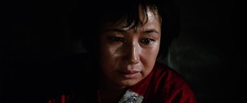 Movie still from “Lady Snowblood” (1973), directed by Toshiya Fujita – A person wearing a red shirt; Close Up shot, Low angle