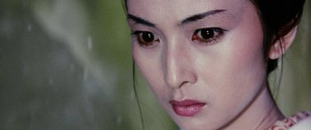 Movie still from “Lady Snowblood” (1973), directed by Toshiya Fujita – A woman's face with brown eyes; Close Up shot, Over the shoulder angle