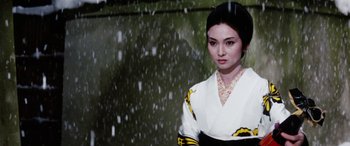 Movie still from “Lady Snowblood” (1973), directed by Toshiya Fujita – A woman in a kimono standing in the rain; Close Up shot, Low angle