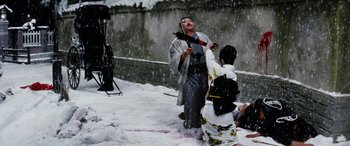 Movie still from “Lady Snowblood” (1973), directed by Toshiya Fujita – A man and a woman dressed in traditional japanese clothing in the snow; Wide shot, High angle