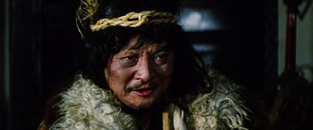 Movie still from “Lady Snowblood” (1973), directed by Toshiya Fujita – A man with a beard and a chain around his neck; Close Up shot, Low angle