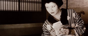 Movie still from “Lady Snowblood” (1973), directed by Toshiya Fujita – A woman holding a piece of paper in her hands; Close Up shot, Low angle