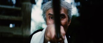 Movie still from “Lady Snowblood” (1973), directed by Toshiya Fujita – An older man with grey hair looking into a mirror; Extreme Close Up shot, Low angle