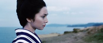 Movie still from “Lady Snowblood” (1973), directed by Toshiya Fujita – A person looking at the ocean; Close Up shot, Low angle