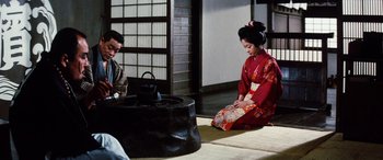 Movie still from “Lady Snowblood” (1973), directed by Toshiya Fujita – A man and a woman dressed in traditional japanese clothing; Wide shot, High angle