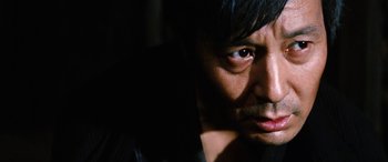 Movie still from “Lady Snowblood” (1973), directed by Toshiya Fujita – A man's face in the dark; Close Up shot, Low angle
