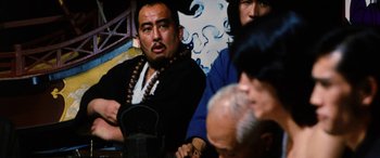 Movie still from “Lady Snowblood” (1973), directed by Toshiya Fujita – A group of people sitting around a table; Close Up shot, Over the shoulder angle