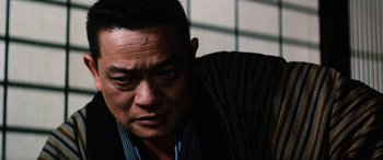 Movie still from “Lady Snowblood” (1973), directed by Toshiya Fujita – A person sitting in a chair; Close Up shot, Low angle