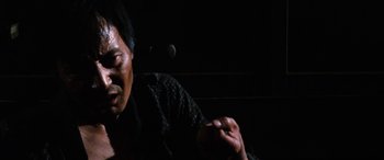 Movie still from “Lady Snowblood” (1973), directed by Toshiya Fujita – An older man sitting in a dark room; Close Up shot, Low angle