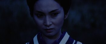Movie still from “Lady Snowblood” (1973), directed by Toshiya Fujita – A person wearing a blue shirt; Close Up shot, Over the shoulder angle