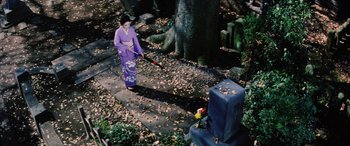 Movie still from “Lady Snowblood” (1973), directed by Toshiya Fujita – A woman in a purple kimono is sweeping leaves; Wide shot, High angle