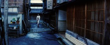 Movie still from “Lady Snowblood” (1973), directed by Toshiya Fujita – A person walking down a street in a city; Extreme Wide shot, High angle