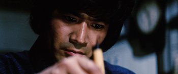 Movie still from “Lady Snowblood” (1973), directed by Toshiya Fujita – A person holding a banana in his hand; Extreme Close Up shot, Low angle